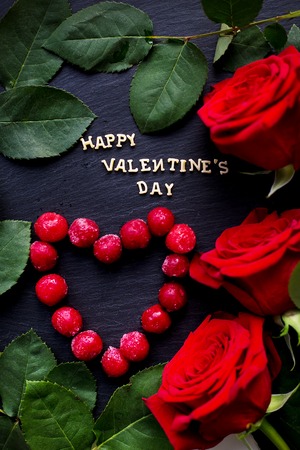 inscription Closeup of Valentine's day, cherry heart-shaped, red roses, ringsの写真素材