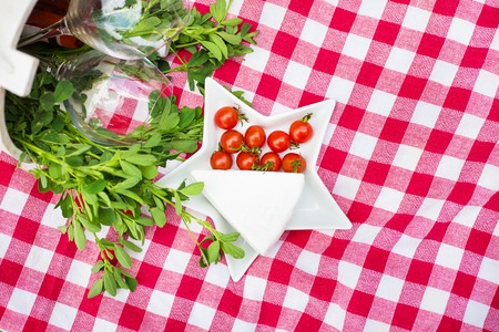 brie cheese and cherry tomatoes on the tableclothの写真素材