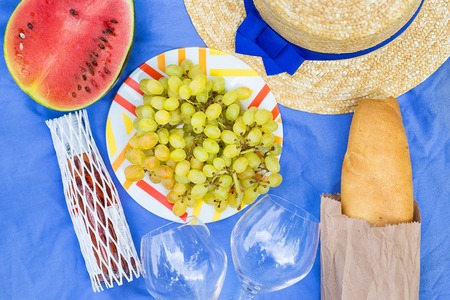 bright summer picnic - hat, glasses, grapes, watermelonの写真素材