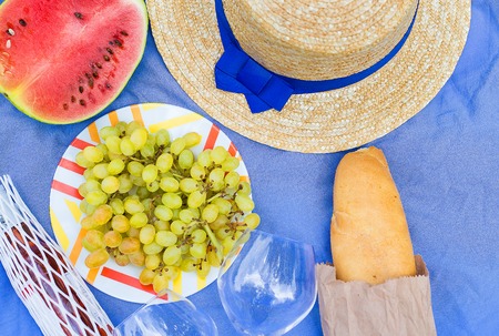 bright summer picnic - hat, glasses, grapes, watermelonの写真素材