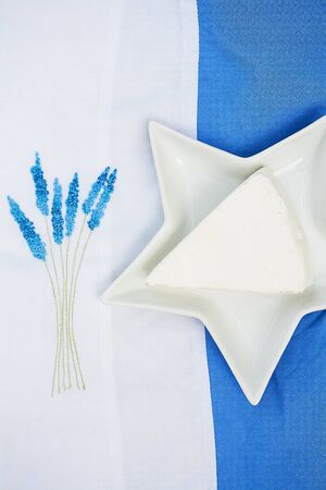 brie cheese in a plate on a blue tableclothの写真素材