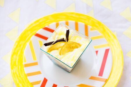 bright colored dessert plate and a yellow napkinの写真素材