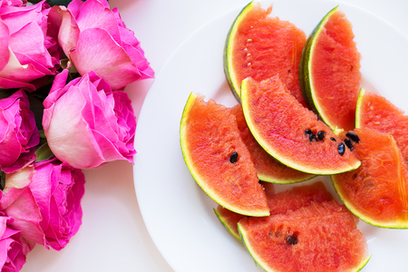 bouquet of pink roses on the table with watermelonの写真素材