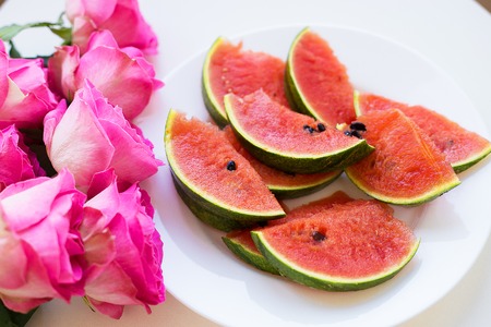 bouquet of pink roses on the table with watermelonの写真素材