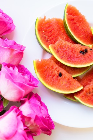 bouquet of pink roses on the table with watermelonの写真素材