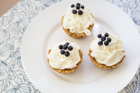 Homemade cupcake with blueberries, cream and fresh berriesの写真素材