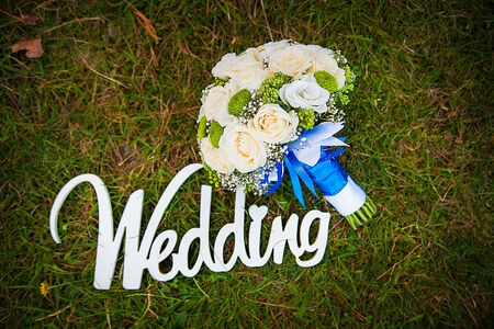 Word of wedding and bridal bouquet outdoorの写真素材