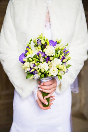 Beautiful wedding bouquet in hands of the brideの写真素材