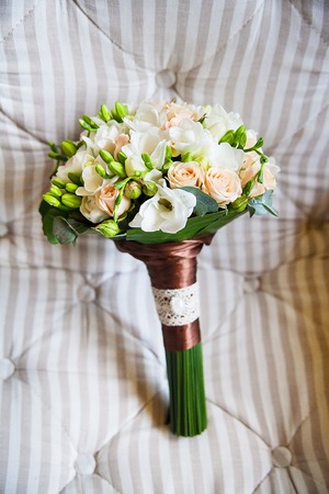 beautiful bridal bouquet lying on the couchの写真素材