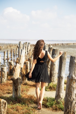 girl enter the sandy beach Kuyalnik Odessa Ukraineの写真素材
