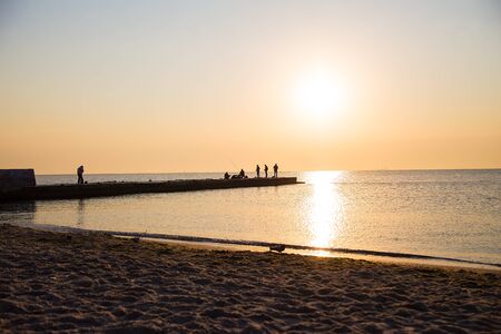fishermen sitting on the beach early in the morning. Odessa