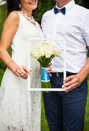 bride and groom holding a beautiful wedding bouquetの写真素材