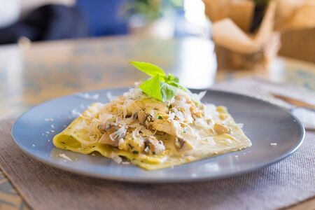 delicious macaroni pasta on a plate in a restaurantの写真素材