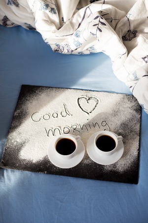good morning inscription flour on a board with cups of coffee, heart Valentine's dayの写真素材