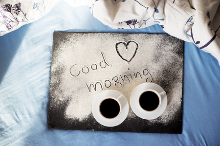 good morning inscription flour on a board with cups of coffee, heart Valentine's dayの写真素材