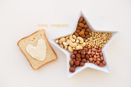 sandwich for breakfast in the form of heart with cheese - good morning inscription bowl and mix with nutsの写真素材