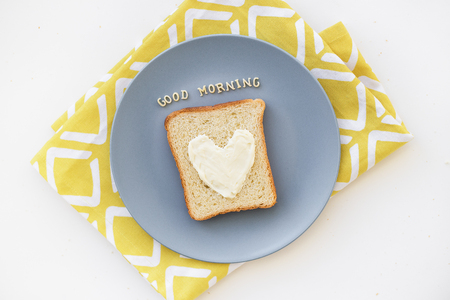sandwich for breakfast in the form of heart with blue cheese on a plate and napkin bright...