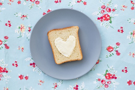 sandwich for breakfast in the form of heart with blue cheese on a plate and napkin brightの写真素材