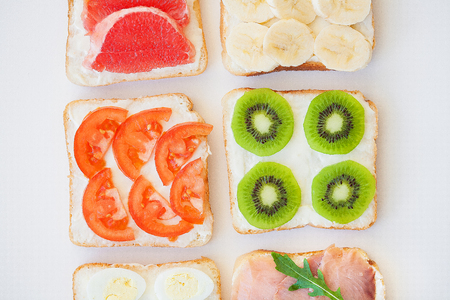 bright mix of sandwiches for breakfast (fruit, vegetables, fish)の写真素材