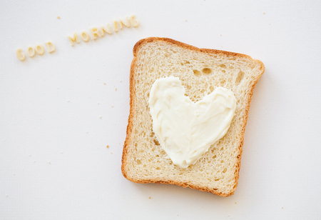 sandwich for breakfast in the form of heart with cheese - good morning inscriptionの写真素材