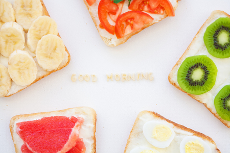 bright mix of sandwiches for breakfast, good morning inscriptionの写真素材