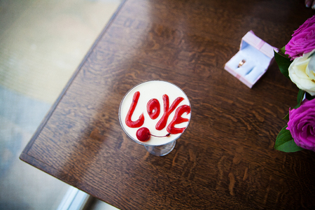 Valentines Day dessert with the words love and cherriesの写真素材