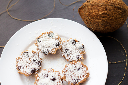 sweet coconut muffins on a white plate on a black boardの写真素材
