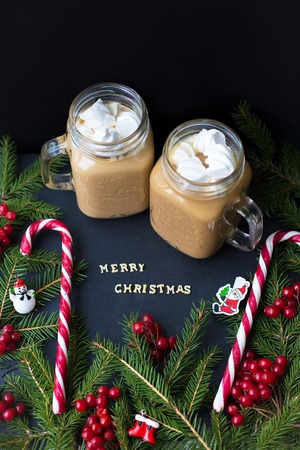 hot cocoa and candy marshmellou on the background of trees. The inscription Merry Christmas.の写真素材
