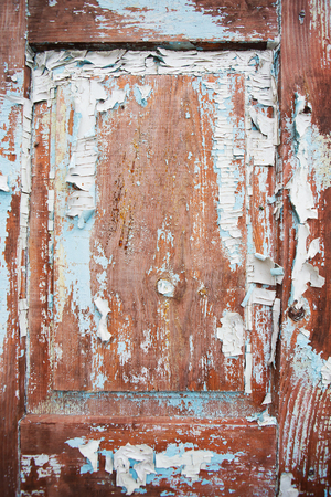 Very old wooden door with cracked blue paint.の写真素材