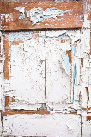 Very old wooden door with cracked white and blue paint.の写真素材