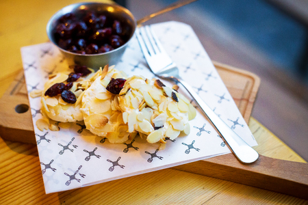 Beautiful presentation Syrnikov sausages with cherry and almond flakes.の写真素材