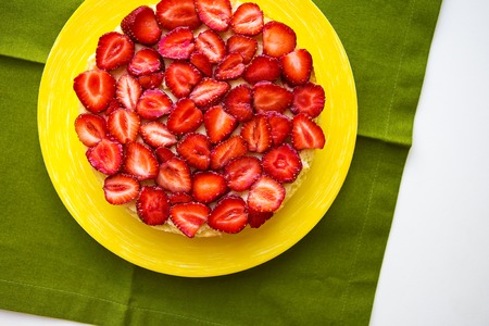 Beautiful strawberry cake is on the table, green napkin.の写真素材