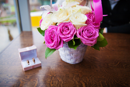 bouquet of beautiful and colorful flowers and wedding rings in a box.の写真素材