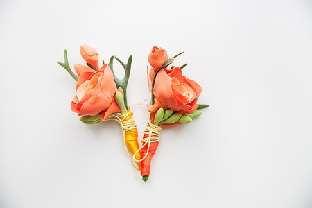 Two Orange Boutonniere on a white background.の写真素材