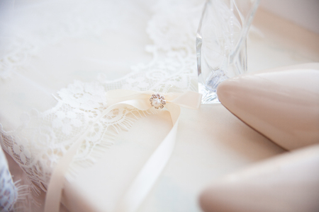 beautiful wedding accessories. Bride shoes, perfumes on a white veil.の写真素材