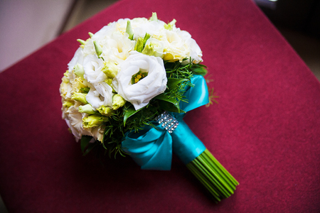 beautiful wedding bouquet on a soft red chair.の写真素材