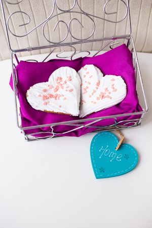 Cookies in the form of heart on a pink napkin inscription home.の写真素材