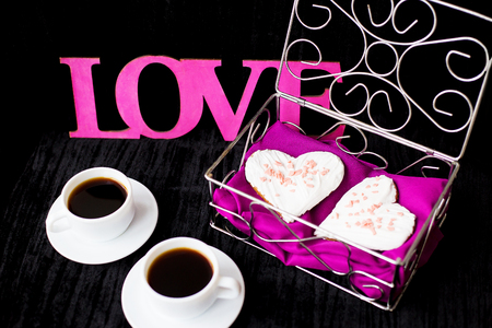 Valentine's Day: two cups of coffee and biscuits in the form of heart.の写真素材