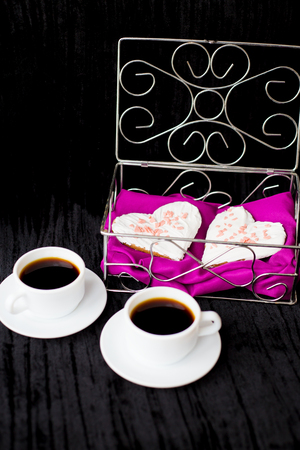 Valentine's Day: two cups of coffee and biscuits in the form of heart.の写真素材