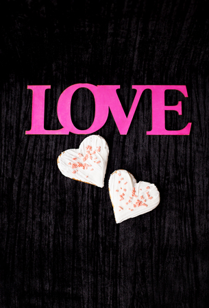 Cookies in the form of heart - pink inscription love.の写真素材