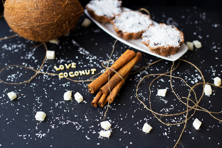 coconut muffins on a black background with words like candied fruits and coconuts, close-upの写真素材