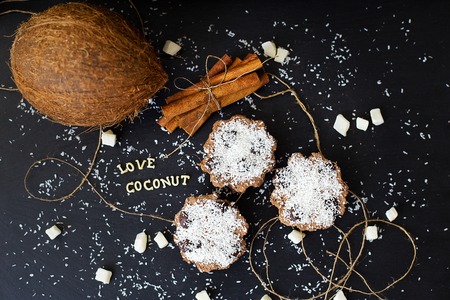 coconut muffins on a black background with words like candied fruits and coconuts, close-upの写真素材