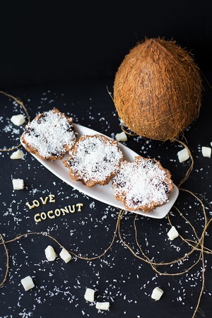 coconut muffins on a black background with words like candied fruits and coconutsの写真素材