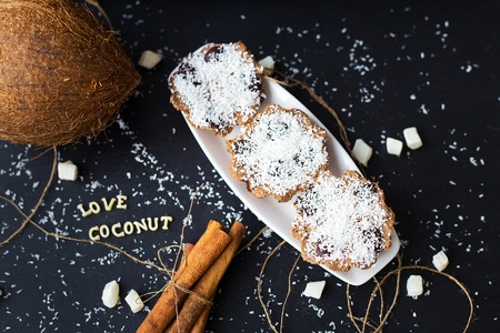 coconut muffins on a black background with words like candied fruits and coconuts, close-upの写真素材