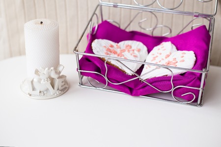 candle and biscuits in the form of heart on a pink napkin.の写真素材