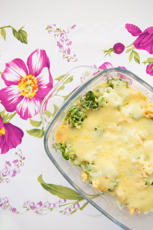 tasty casserole with broccoli on colorful napkin with pink flowersの写真素材