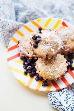 Blueberry muffins on plate and bright floral napkin, close-upの写真素材