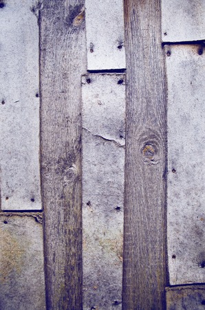 Very old abandoned wooden fence nailed to the nails.の写真素材