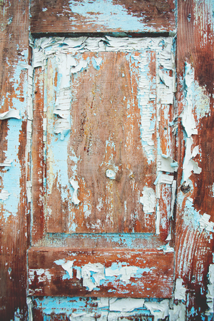 Very old wooden door with cracked blue paint.の写真素材