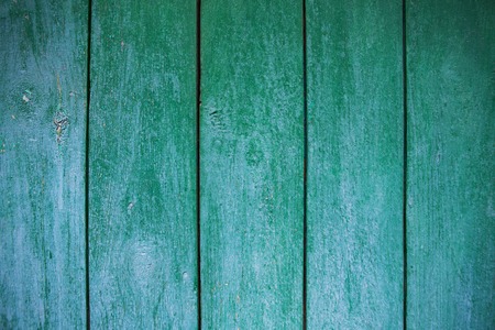 Shabby and very old wooden fence - cracked paint.の写真素材